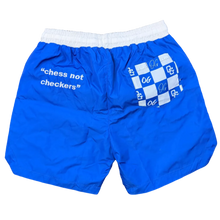 Load image into Gallery viewer, Blue shorts with white text on a brown carpet