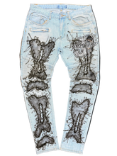 Load image into Gallery viewer, Light blue jeans with black graphic designs and text on a white background
