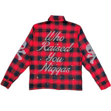 Load image into Gallery viewer, Red and black plaid shirt with text on a gray surface