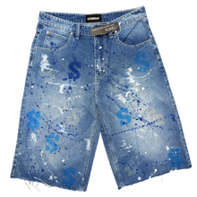 Load image into Gallery viewer, Blue denim shorts with white and blue splatter design on a beige carpet