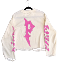 Load image into Gallery viewer, White hoodie with pink graphics on a gray surface
