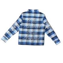 Load image into Gallery viewer, Blue and white striped shirt with long sleeves on a beige carpet
