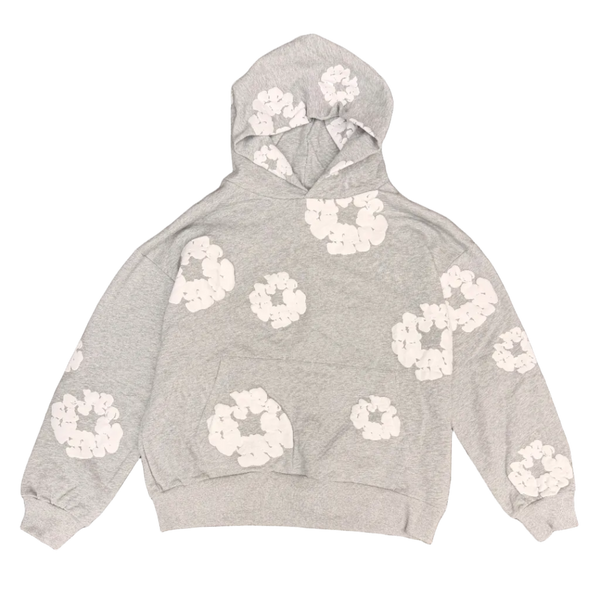 Gray hoodie with white floral patterns on a brown carpet