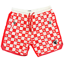 Load image into Gallery viewer, Red and white checkered pouch with cartoon face design on a brown surface next to black Crocs shoes.
