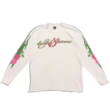 Load image into Gallery viewer, White long-sleeve shirt with floral designs and text on a black background
