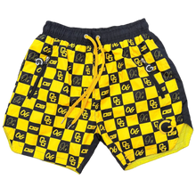 Load image into Gallery viewer, Yellow and black checkered shorts on a gray surface
